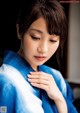 A woman in a blue and white kimono poses for a picture.