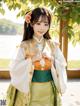 A woman in a green and orange hanbok posing for a picture.